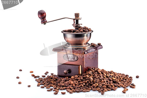 Image of Retro manual coffee mill on roasted coffee beans isolated