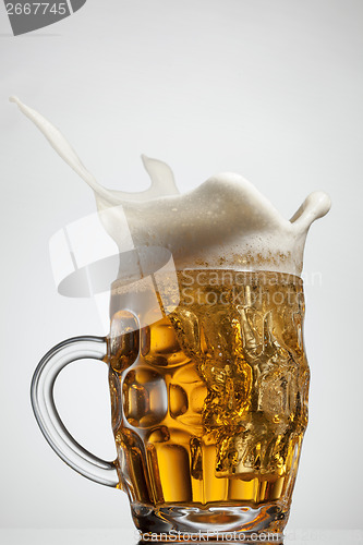 Image of Beer splash in glass isolated on white