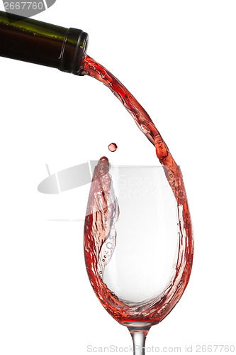 Image of Red wine pouring into glass with splash isolated on white