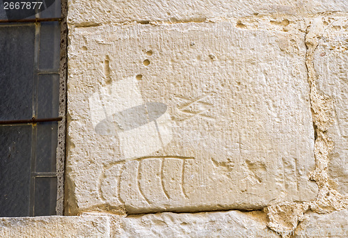 Image of stonemason marks etched in stone