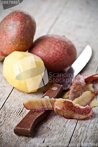Image of healthy organic peeled potatoes and knife 