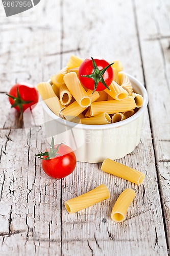Image of uncooked pasta and cherry tomatoes in a bowl 