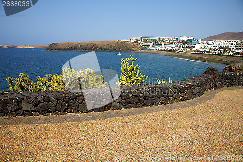 Image of cactus coastline   in spain   pond beach   yacht boat   summer 