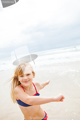 Image of Young girl having fun at beach