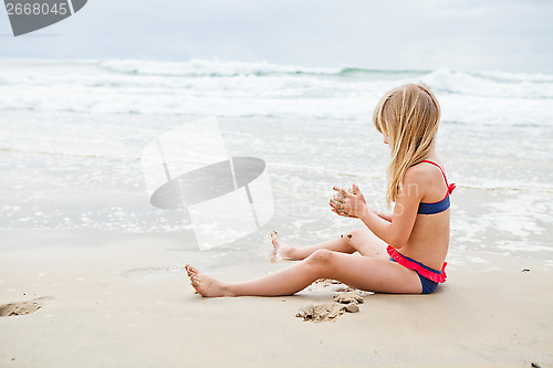 Image of Young girl playing at beach