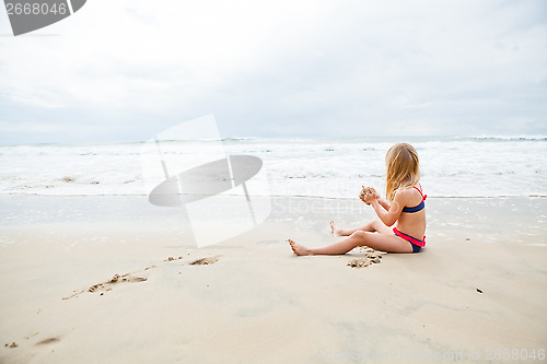 Image of Young girl playing at beach