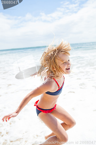 Image of Young girl having fun at beach
