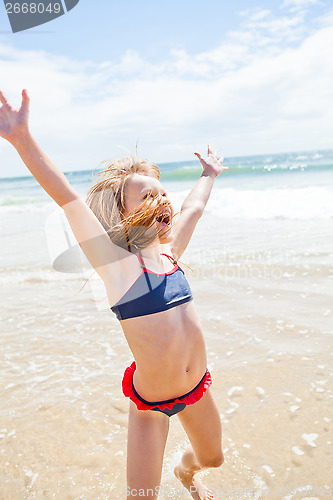 Image of Young girl having fun at beach