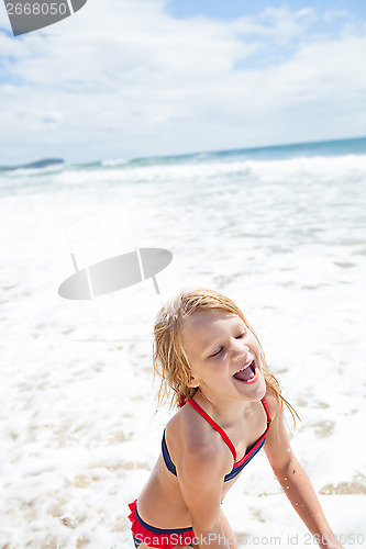 Image of Young girl having fun at beach