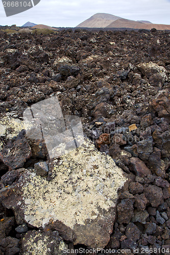 Image of volcanic stone in los volcanes   rock  sky  hill and summer 