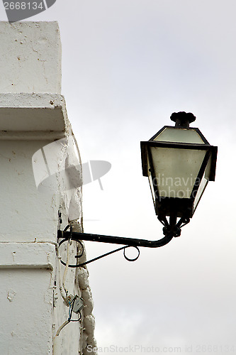 Image of spain street lamp a bulb in the cloudy sky 