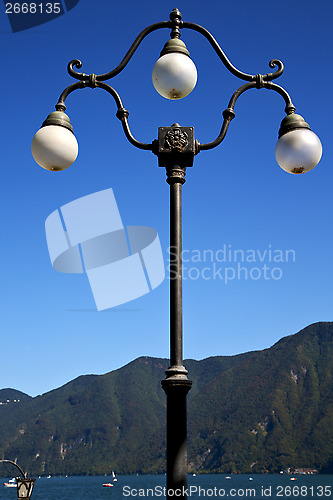 Image of street lamp a bulb in the   sky lake of lugano Switzerland 