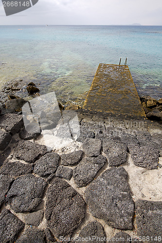 Image of pier rusty chain  water  boat yacht  lanzarote spain
