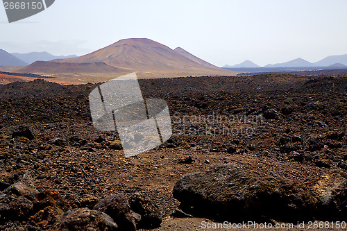 Image of volcanic  lanzarote  spain  timanfaya  rock  sky  hill and summe