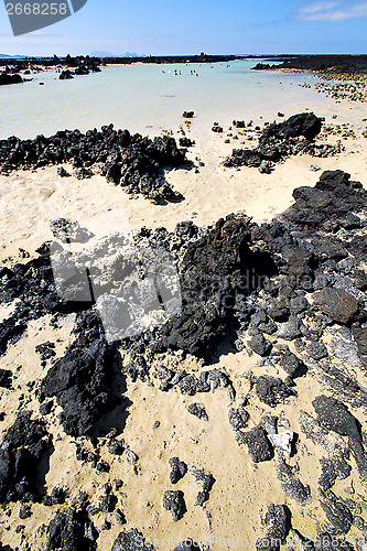 Image of people of black rocks in the   lanzarote 
