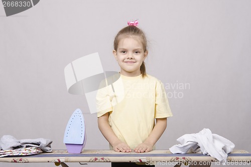 Image of girl prepares to start ironed linen