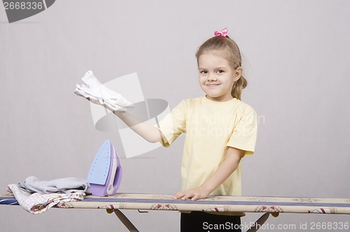 Image of girl happy stroking things iron