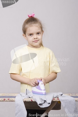 Image of five year old girl stroking lingerie