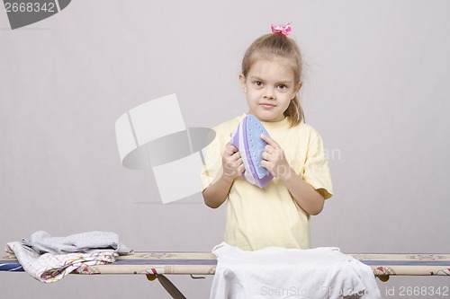 Image of girl stands with iron hands