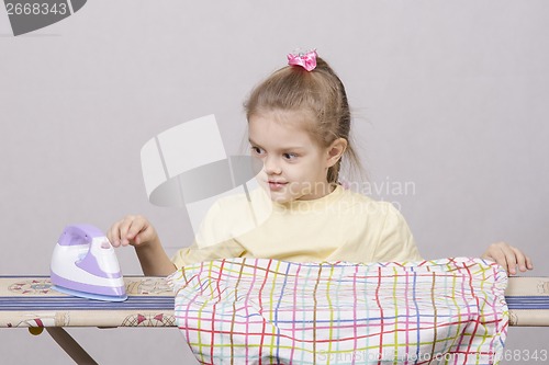 Image of girl petting iron