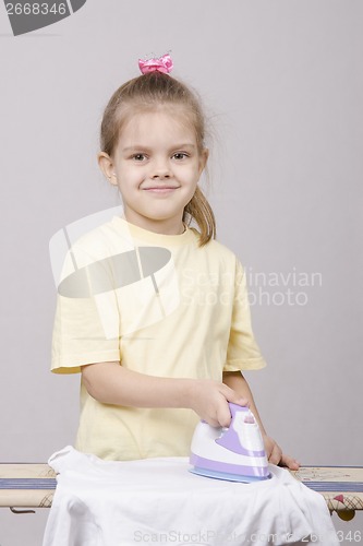 Image of girl housewife ironed linen