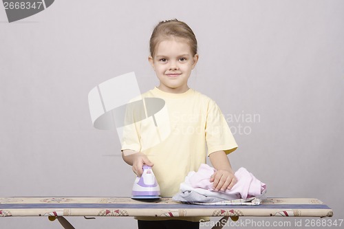 Image of The child stroking things iron