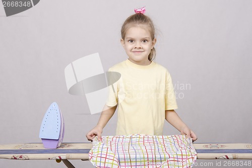 Image of the child turns underwear when Ironing