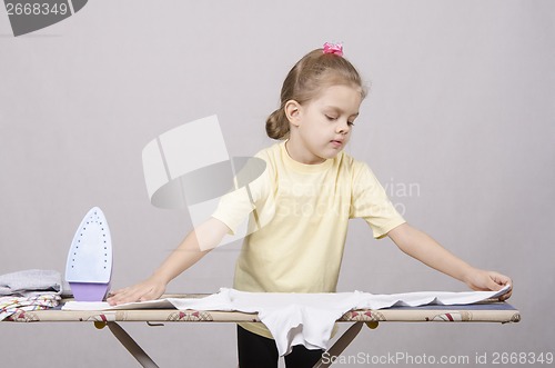 Image of the girl gently stroking things iron