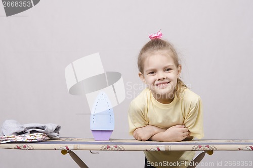 Image of the girl smiles at Ironing Board