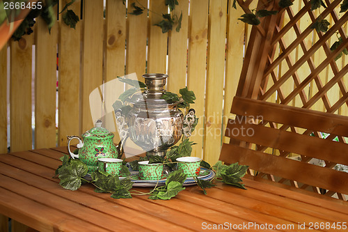 Image of National Russian tradition to drink tea from a samovar.