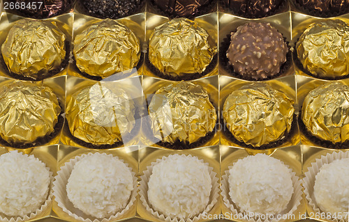Image of Chocolate sweets in the box on the white background.