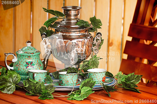 Image of National Russian tradition to drink tea from a samovar.