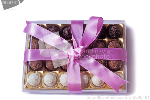 Image of Beautifully decorated and tied with a ribbon candy box on a whit