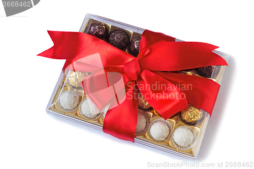 Image of Beautifully decorated and tied with a ribbon candy box on a whit