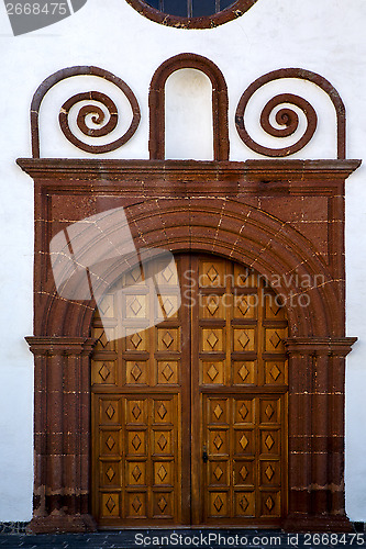 Image of  lanzarote  spain canarias brass    closed wood  church  wall ab