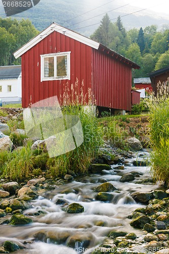 Image of Red wooden cabin at campsite