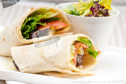 Image of kafta shawarma chicken pita wrap roll sandwich