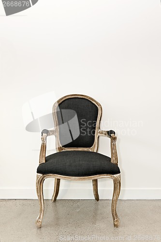 Image of Antique armchair near wall