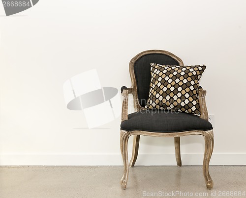 Image of Antique armchair near wall