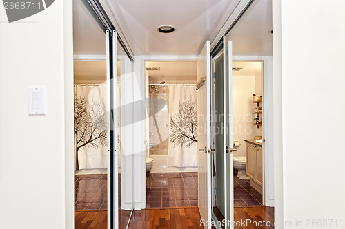 Image of Mirrored closets and bathroom