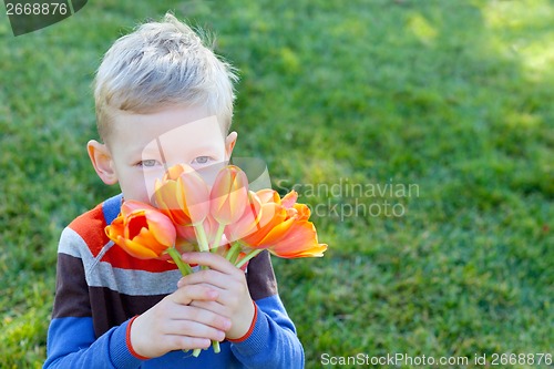 Image of boy holding flowers