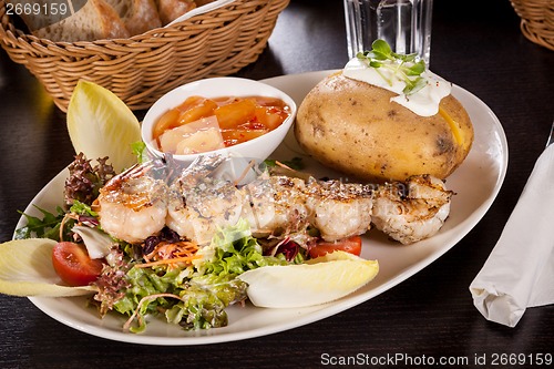 Image of Grilled prawns with endive salad and jacket potato