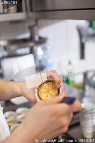 Image of Chef preparing desserts removing them from moulds