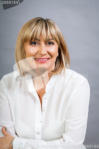 Image of Smiling confident middle-aged blond woman