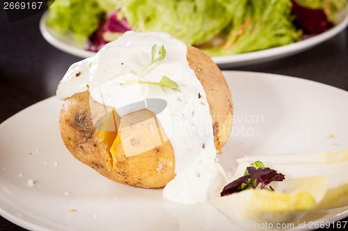 Image of Baked jacket potato with sour cream sauce