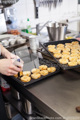 Image of Chef preparing desserts removing them from moulds