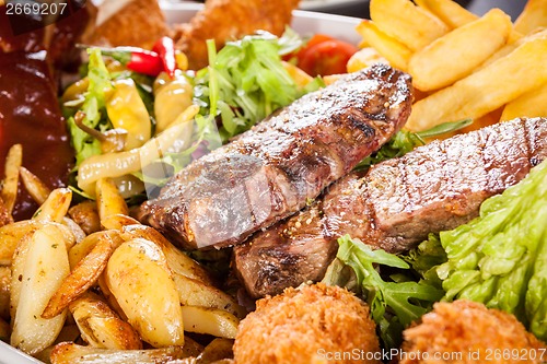 Image of Platter of mixed meats, salad and French fries