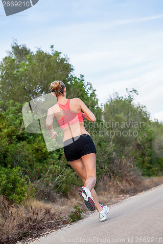 Image of young athletic woman runner jogger outdoor