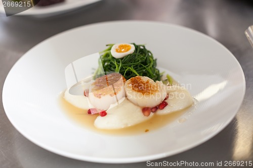 Image of Delicious starter of stuffed savoury eggs and scallops