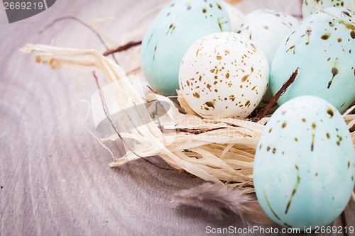 Image of Three natural blue Easter eggs in a basket